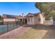 View of the exterior of the home with a fenced pool, desert landscaping and solar panels at 6332 Sierra Pines Ct, Las Vegas, NV 89130