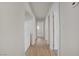 Bright hallway with wood-look floors leads to bedrooms and laundry area, offering a clean and modern transition space at 6332 Sierra Pines Ct, Las Vegas, NV 89130
