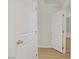 Hallway featuring white doors with brass hardware and laminate flooring at 6332 Sierra Pines Ct, Las Vegas, NV 89130