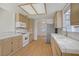 Sunlit kitchen featuring tile countertops, stainless steel refrigerator, and white appliances at 6332 Sierra Pines Ct, Las Vegas, NV 89130