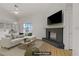 Staged living room featuring a brick fireplace and ample natural light at 6332 Sierra Pines Ct, Las Vegas, NV 89130