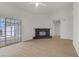 Bright living room featuring fireplace, wood floors, and sliding door to backyard at 6332 Sierra Pines Ct, Las Vegas, NV 89130
