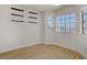 Bright room featuring three windows providing plenty of natural light and laminate flooring at 6332 Sierra Pines Ct, Las Vegas, NV 89130