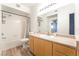 Well-lit bathroom with a shower-tub and a vanity with cabinets for storage at 6955 N Durango Dr # 2099, Las Vegas, NV 89149