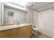 This bathroom features wood cabinets, a large mirror, a bathtub, and wood-look vinyl flooring at 6955 N Durango Dr # 2099, Las Vegas, NV 89149