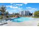 Relaxing pool area with waterfall feature, lounge chairs, and lush landscaping at 6955 N Durango Dr # 2099, Las Vegas, NV 89149