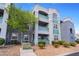 Exterior view of a three-story condominium building with well-maintained landscaping at 6955 N Durango Dr # 2099, Las Vegas, NV 89149