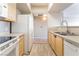 Open-concept kitchen with stainless steel appliances and modern wooden cabinets at 6955 N Durango Dr # 2099, Las Vegas, NV 89149