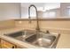 Close-up of a stainless steel kitchen sink with a modern faucet and light countertops at 6955 N Durango Dr # 2099, Las Vegas, NV 89149