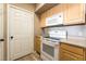 Well-lit kitchen with an oven and a microwave, complemented by wooden cabinets at 6955 N Durango Dr # 2099, Las Vegas, NV 89149