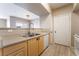 Bright kitchen featuring stainless steel sink, wooden cabinets, and modern appliances at 6955 N Durango Dr # 2099, Las Vegas, NV 89149