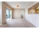 Open-concept living space with balcony access and a view of the kitchen at 6955 N Durango Dr # 2099, Las Vegas, NV 89149