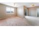Spacious living room with a ceiling fan, large window, and sliding glass door at 6955 N Durango Dr # 2099, Las Vegas, NV 89149