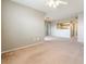 Bright living room with neutral walls, a ceiling fan, and an open view to the kitchen at 6955 N Durango Dr # 2099, Las Vegas, NV 89149