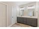 Bathroom featuring double sinks, modern lighting, and hardwood floors at 790 Lone Pine Rd, Pahrump, NV 89048