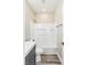 Bright bathroom featuring a white tiled shower-tub combination and wood-look flooring at 790 Lone Pine Rd, Pahrump, NV 89048