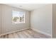 Bright bedroom featuring wood-look floors, neutral walls, and a window with natural light at 790 Lone Pine Rd, Pahrump, NV 89048