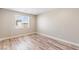 Bright empty bedroom featuring hardwood floors, white walls and trim, and a large window at 790 Lone Pine Rd, Pahrump, NV 89048