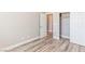 Neutral bedroom with wood-look floors, closet, and view into hall at 790 Lone Pine Rd, Pahrump, NV 89048