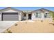 Charming single-story home with a neutral exterior, attached garage, and desert landscaping at 790 Lone Pine Rd, Pahrump, NV 89048