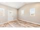 Spacious living area filled with natural light, light walls, recessed lights and wood look flooring at 790 Lone Pine Rd, Pahrump, NV 89048