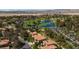Scenic aerial view of homes with a lake, golf course, lush landscaping in a community at 8244 Horseshoe Bend Ln, Las Vegas, NV 89113
