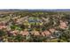 Scenic aerial view of homes with a lake, golf course, lush landscaping in a community at 8244 Horseshoe Bend Ln, Las Vegas, NV 89113