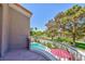 A balcony overlooking a lush backyard with a swimming pool and mature trees provides a serene outdoor retreat at 8244 Horseshoe Bend Ln, Las Vegas, NV 89113