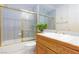 Bright bathroom with a tiled shower, a soaking tub and a wood vanity at 8244 Horseshoe Bend Ln, Las Vegas, NV 89113