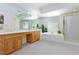 Large primary bathroom features a double vanity, bathtub, glass block window, and separate shower stall at 8244 Horseshoe Bend Ln, Las Vegas, NV 89113