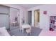 Bright bedroom with a built-in bookcase, plush carpet, a ' table set and mirror closet at 8244 Horseshoe Bend Ln, Las Vegas, NV 89113