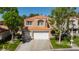 Charming two-story home with a three-car garage, lush green lawn, and mature landscaping at 8244 Horseshoe Bend Ln, Las Vegas, NV 89113