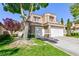 Attractive stucco home with a terracotta roof, three car garage, and lush, mature landscaping at 8244 Horseshoe Bend Ln, Las Vegas, NV 89113