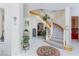 Grand foyer with a curved staircase, tiled floor, and decorative rug at 8244 Horseshoe Bend Ln, Las Vegas, NV 89113