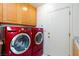 Functional laundry area equipped with side-by-side red washer and dryer units at 8244 Horseshoe Bend Ln, Las Vegas, NV 89113