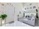 Bright living room featuring a white sectional sofa and large windows with plantation shutters at 8244 Horseshoe Bend Ln, Las Vegas, NV 89113