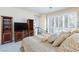 Comfortable bedroom with shuttered windows, TV and wooden cabinets offers a relaxing retreat at 8244 Horseshoe Bend Ln, Las Vegas, NV 89113