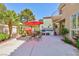 Outdoor patio with dining set, outdoor grill, stucco wall, mature trees, and red umbrella at 8244 Horseshoe Bend Ln, Las Vegas, NV 89113