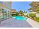 Backyard with a pool, mature landscaping, patio, and sliding doors to the interior at 8244 Horseshoe Bend Ln, Las Vegas, NV 89113