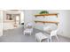 Inviting seating area with white wicker furniture and floating wood shelves offer a relaxing retreat at 8244 Horseshoe Bend Ln, Las Vegas, NV 89113