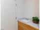 Practical utility sink area with wood cabinets and gray tile countertops at 8244 Horseshoe Bend Ln, Las Vegas, NV 89113