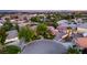 Beautiful aerial view of a home with lush landscaping, a circular driveway and mature trees in a desirable neighborhood at 8275 W Craig Rd, Las Vegas, NV 89129