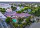 This aerial view highlights the backyard oasis with a pool, lush landscaping, and manicured lawns at 8275 W Craig Rd, Las Vegas, NV 89129