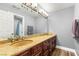 Bathroom with double sinks, granite countertops, and a large mirror at 8275 W Craig Rd, Las Vegas, NV 89129