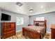 Cozy bedroom with wood furniture, plush bedding, and natural light at 8275 W Craig Rd, Las Vegas, NV 89129