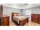 Comfortable bedroom with a wooden bed frame, neutral tones, and natural light from the windows at 8275 W Craig Rd, Las Vegas, NV 89129