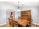 Bright dining room with wood floors and a large wood table with seating for eight at 8275 W Craig Rd, Las Vegas, NV 89129