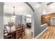 Dining room features a wooden table with seating for eight, hardwood floors, and natural lighting at 8275 W Craig Rd, Las Vegas, NV 89129