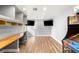 Spacious entertainment room with dual wall-mounted televisions and custom built-in shelving at 8275 W Craig Rd, Las Vegas, NV 89129
