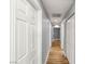 Bright hallway with wood floors, neutral paint, and modern doors at 8275 W Craig Rd, Las Vegas, NV 89129